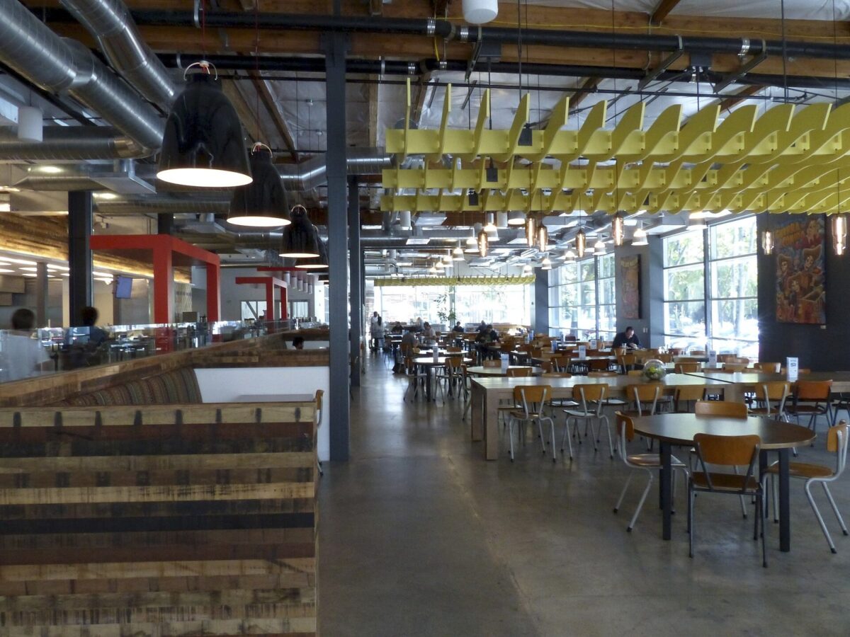 Google本社の社員食堂。天井の高い広い部屋に、木のテーブルといすがずらりと並んでいる