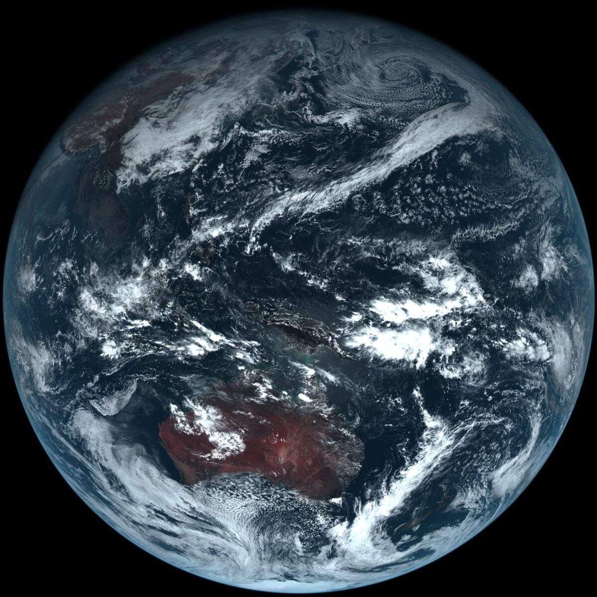 黒い宇宙に浮かぶ丸い地球。日本やオーストラリア、アジアの陸地と、白い雲のうずが見える